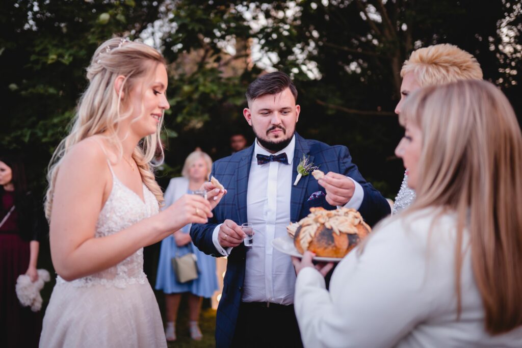 wesele w ogrodzie, chleb i sól, wódka, fotograf ślubny, Koszalin, Polanów, powitanie młodej pary rodzice, młoda para