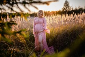 sesja ciążowa, fotograf Koszalin, Barbara Rompska, przyszła mama, koronkowa sukienka ciążowa, boho, wysoka trawa, zachód słońca