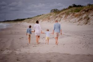 plenerowa sesja rodzinna, Mielno, fotograf Koszalin, Morze Bałtyckie, Barbara Rompska, niebieska koszula, beżowe spodenki, plaża, spacer